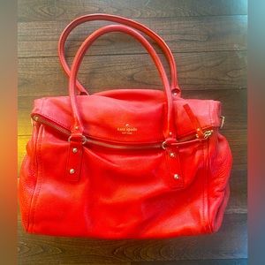 Kate Spade handbag in red leather with zipper top fold over closure